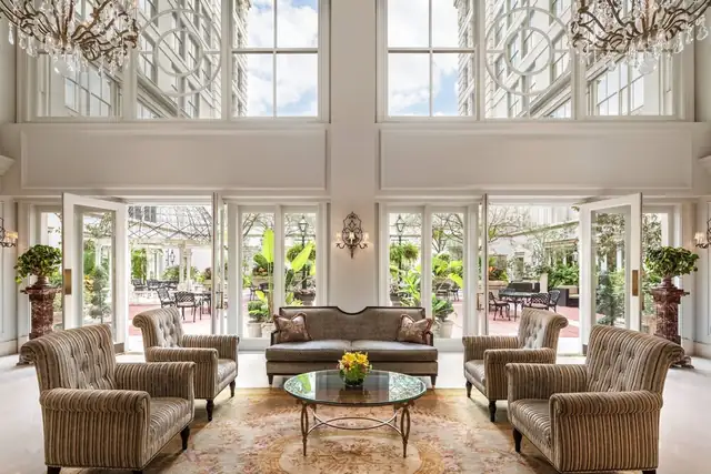 The Ritz-Carlton in New Orleans, spacious sitting room with large window, sofa, armchairs