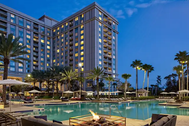 Waldorf Astoria Orlando in Orlando, pool with lounge chairs and palm trees